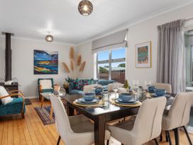 A dining room with table and chairs at Ohope