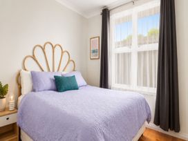 A bedroom with a bed and window at Coastal Haven Retreat - 4 Bedrooms Ohope Beach