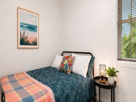 A bedroom with a bed and a window at Coastal Haven Retreat - 4 Bedrooms Ohope Beach