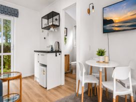 A kitchen with table and chairs at Coastal Haven Retreat - 4 Bedrooms Ohope Beach