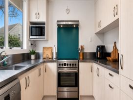 A kitchen with an oven and microwave at Coastal Haven Retreat - 4 Bedrooms Ohope Beach