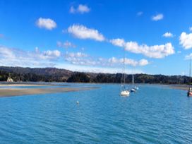 A scenic view with boats on water at Coastal Haven Retreat - 4 Bedrooms Ohope Beach