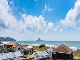 View of the ocean and houses at Coastal Haven Retreat - 4 Bedrooms Ohope Beach