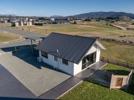 A house with a gravel area and patio at The Tranquil Edge - Te Anau Holiday Home Te Anau