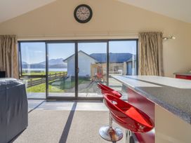 A living room with a view of the landscape at The Tranquil Edge - Te Anau Holiday Home Te Anau