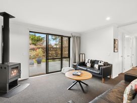 A living room with a stove and sofa at Vista Haven - Bannockburn Holiday Home Bannockburn