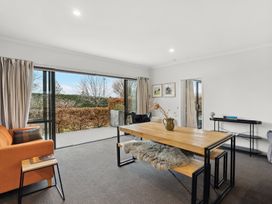 A living room with a table, chairs, and a sofa at Vista Haven - Bannockburn
