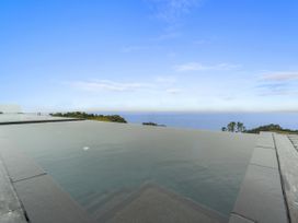 An infinity pool with steps overlooking the ocean at The Glasshouse at Block295 Raglan