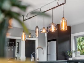 A kitchen featuring pendant lights and a sink at The Glasshouse at Block295 Raglan