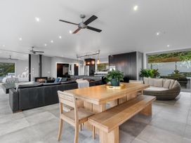 An open plan living area with dining table and sofa at The Glasshouse at Block295 Raglan