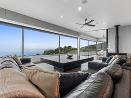 A living room with a view of the ocean at The Glasshouse at Block295 Raglan
