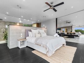 A bedroom with a bed and bedside table at The Glasshouse at Block295 Raglan
