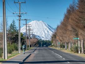 A road with a snowy mountain and trees at The Flax Cottage - National Park Holiday Home in National Park