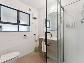 A bathroom with a shower and sink at The Flax Cottage - National Park Holiday Home