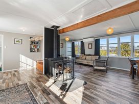 A living room with a fireplace and sofa at The Flax Cottage - National Park Holiday Home