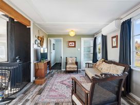 A living room with a fireplace and sofa at The Flax Cottage - National Park Holiday Home in National Park