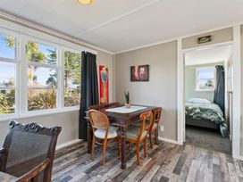A dining room with a table and chairs at The Flax Cottage - National Park