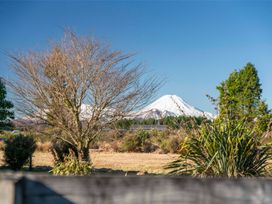 A view of a mountain in the background with trees in the foreground at The Flax Cottage - National Park