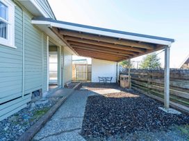 An outdoor area with a patio, table, and chairs at The Flax Cottage - National Park