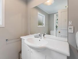 A bathroom with sink and mirror at Acacia Horizons - Taupo Holiday Home in Acacia Bay