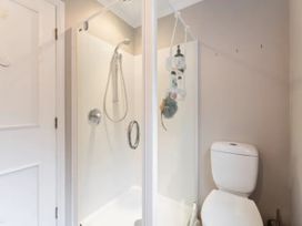 A shower and toilet in a bathroom at Acacia Horizons - Taupo Holiday Home Acacia Bay