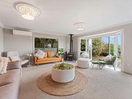 A living room with a sofa and coffee table at Acacia Horizons - Taupo Holiday Home Acacia Bay