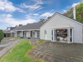 An outdoor area with a view of a house and pathway at Acacia Horizons - Taupo Holiday Home Acacia Bay