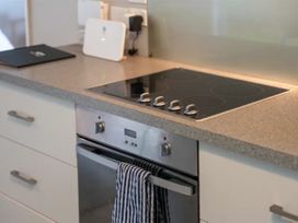 A kitchen with an oven and stovetop at Acacia Horizons - Taupo Holiday Home, Acacia Bay