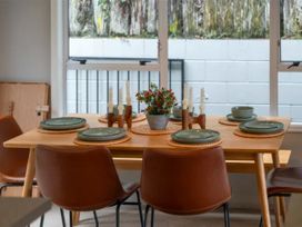 A dining room with a table and chairs at Acacia Horizons - Taupo Holiday Home Acacia Bay