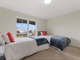 A bedroom with two beds and a window at Acacia Horizons - Taupo Holiday Home, Acacia Bay