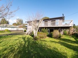 A house with a deck and garden at Rotorua Holiday Home in Rotorua