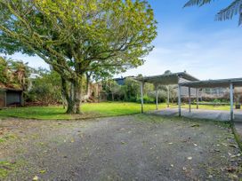 An outdoor space with a tree and shelter at Rotorua Holiday Home, Rotorua