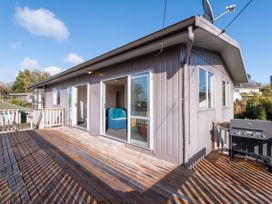 An outdoor space with a deck and a grill at Rotorua Holiday Home in Rotorua