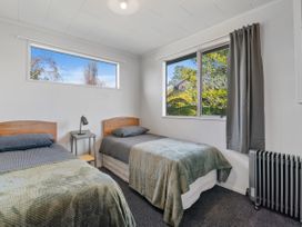 A bedroom with two beds and a window at Rotorua Holiday Home in Rotorua
