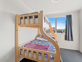 A bedroom with a bunk bed and a window at Rotorua Holiday Home in Rotorua