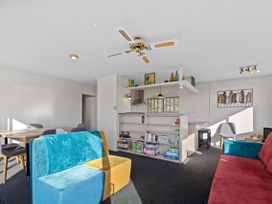 A living room with a dining table and sofa at Rotorua Holiday Home in Rotorua