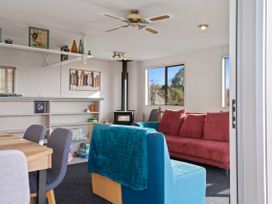 A living room with a sofa and dining table at Rotorua Holiday Home in Rotorua