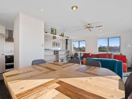 A living room with a dining table and sofa at Rotorua Holiday Home in Rotorua