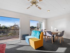 A dining area with a table and chairs at Rotorua Holiday Home in Rotorua