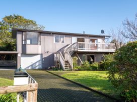 A house with a balcony and garage door at Rotorua Holiday Home Rotorua