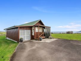 A house exterior with a driveway and grass at Rotorua in Rotorua