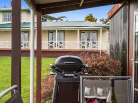 An outdoor area with a barbecue grill and a view of a building at Rotorua