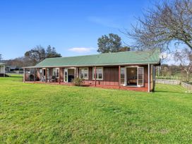 A house with a porch and garden area at Rotorua