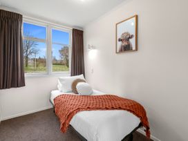 A bedroom with a bed and window at Rotorua