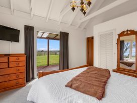 A bedroom with a bed and dresser at Rotorua