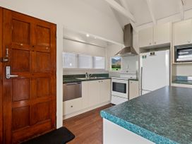 A kitchen with a door and appliances at Rotorua