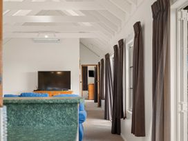 A living room with a television and sofa at Rotorua