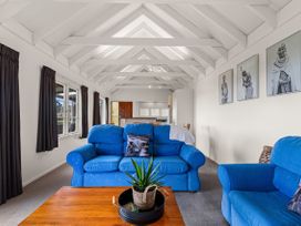 A living room with blue sofas and a coffee table at Rotorua, Rotorua