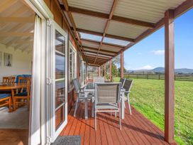 An outdoor deck with a table and chairs at Rotorua in Rotorua
