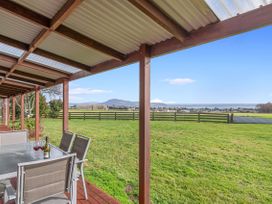 An outdoor dining area with a table and chairs at Rotorua in Rotorua